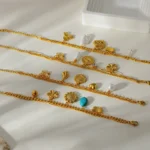 Doyours – Bracciale multifascino in acciaio inox placcato oro 18K con cuore, farfalla, girasole e occhio - immagine 2