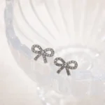 Orecchini mini fiocco in zircone CZ color oro - immagine 5