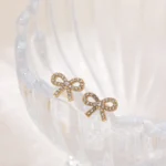 Orecchini mini fiocco in zircone CZ color oro - immagine 4