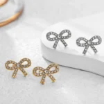 Orecchini mini fiocco in zircone CZ color oro